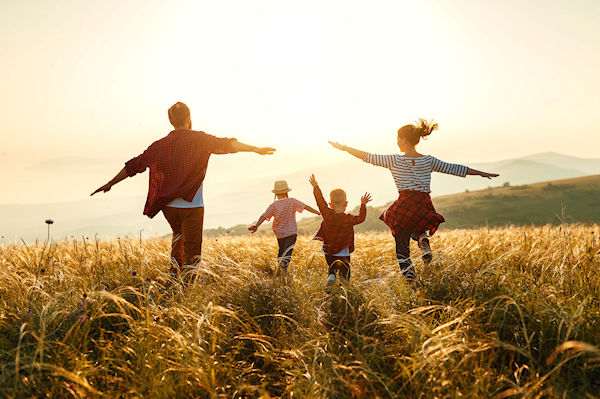 Happy family: mother, father, children son and  daughter on nature  on sunset